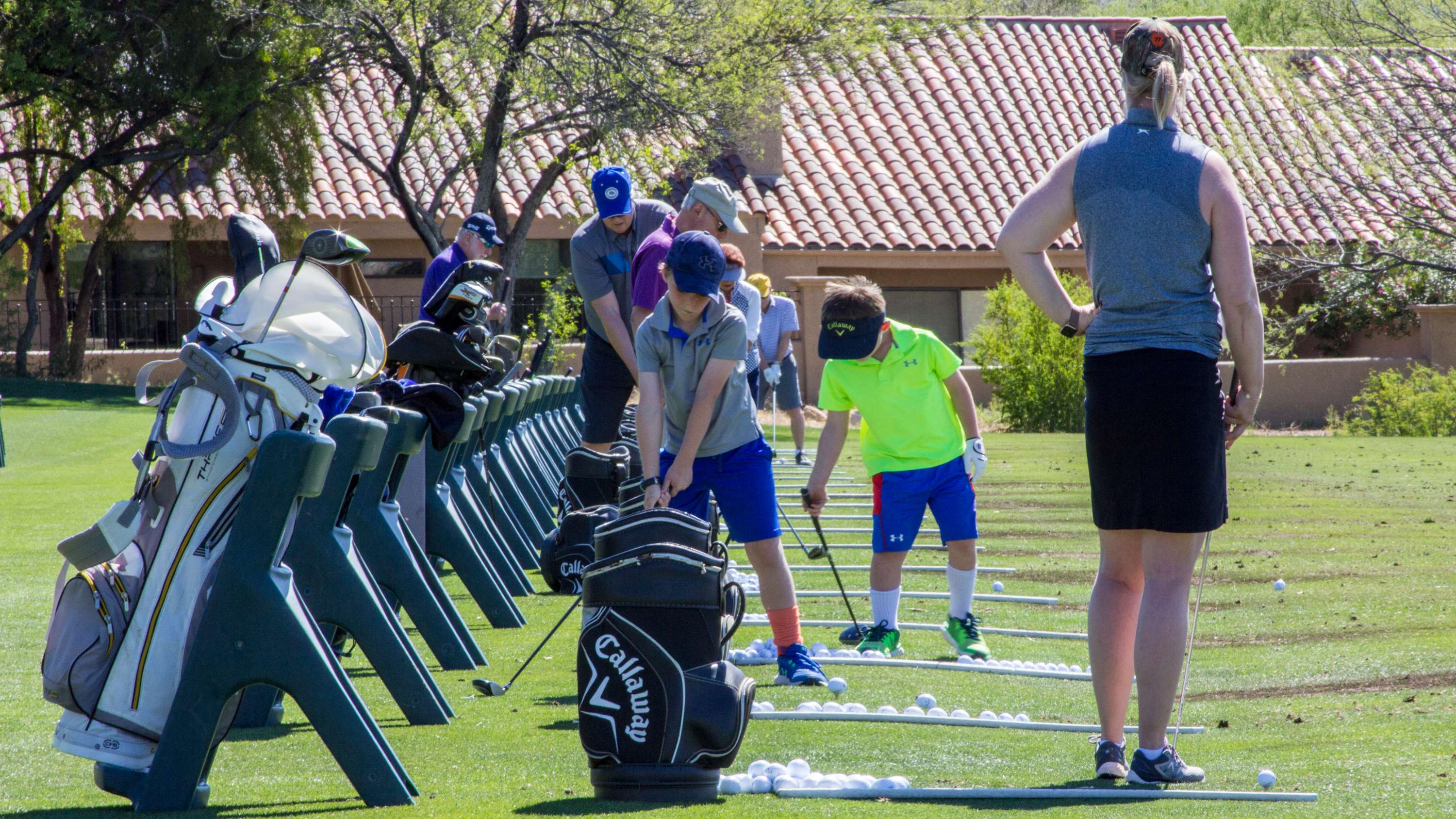 Golfing range with people practicing